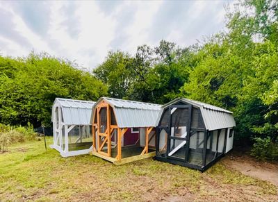White, natural and black: Three barn coops side by side, one in each finish.