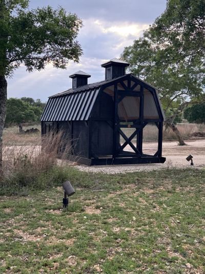 Custom black coop: Settled in under the live oaks.