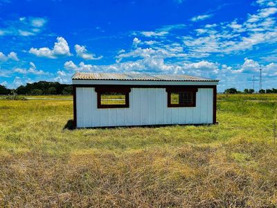 Side of a loafing shed showing the roof sloping from front to back